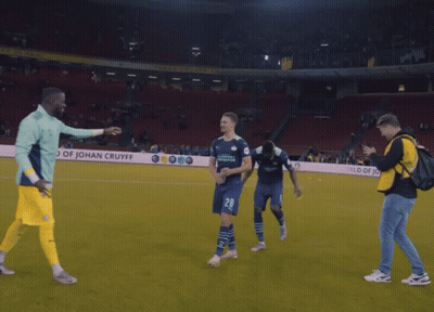 A Soccer Player Wearing A Number 28 Jersey Is Hugging Another Player GIF