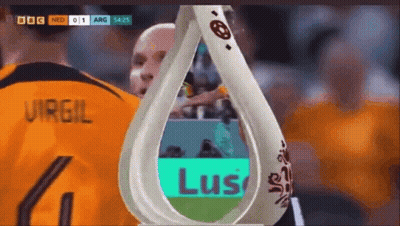 A Soccer Player Wearing A Number 4 Jersey Stands Next To A Trophy GIF