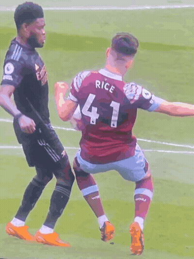 A Soccer Player Wearing A Number 41 Jersey Is Being Tackled By Another Player GIF