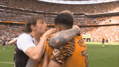 A Soccer Player Wearing A Number 5 Jersey Is Hugging Another Player GIF