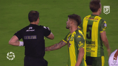 A Soccer Player Wearing A Number 5 Jersey Talks To Another Player GIF