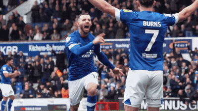 A Soccer Player Wearing A Number 7 Jersey Celebrates With His Teammate GIF