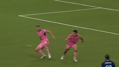 A Soccer Player Wearing A Number 77 Jersey Stands In Front Of A Net GIF