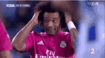 A Soccer Player Wearing A Pink Fly Emirates Jersey Is Holding His Hair . GIF