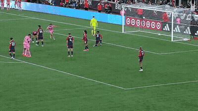 A Soccer Player Wearing A Pink Jersey With Suarez On The Back Is Hugging Another Player GIF