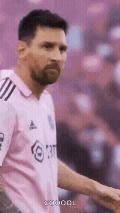 A Soccer Player Wearing A Pink Shirt Is Standing On A Field . GIF