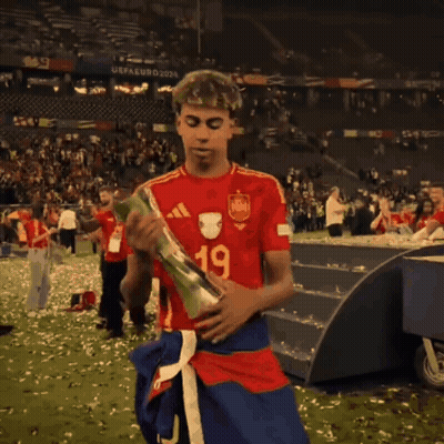 A Soccer Player Wearing A Qatar Airways Jersey Is Holding A Trophy GIF