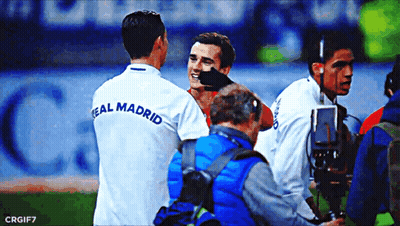 A Soccer Player Wearing A Real Madrid Shirt Talks To Another Player GIF