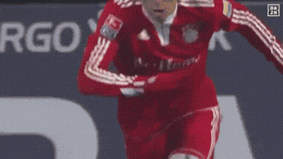 A Soccer Player Wearing A Red Adidas Jersey Is Running On The Field GIF