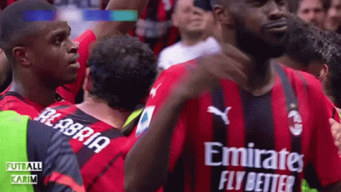 A Soccer Player Wearing A Red And Black Jersey With Emirates Fly Better Written On It GIF