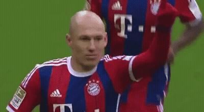 A Soccer Player Wearing A Red And Blue Adidas Jersey Is Giving A High Five . GIF
