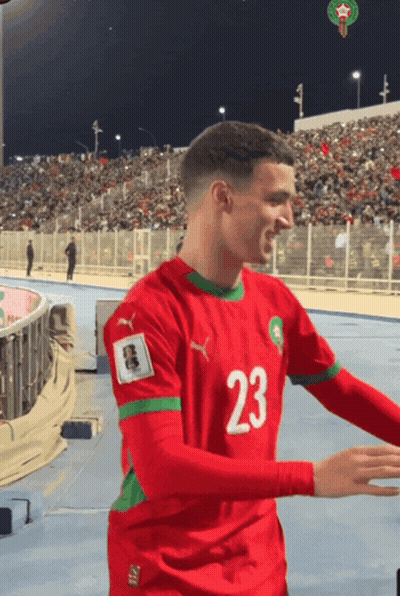 A Soccer Player Wearing A Red And Green Jersey With The Number 23 On It GIF