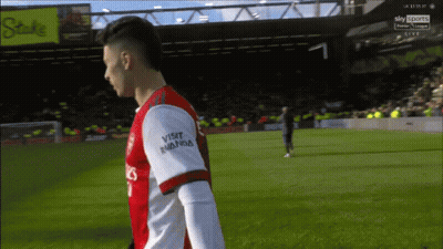 A Soccer Player Wearing A Red And White Jersey That Says Visit Rwanda On The Sleeve GIF