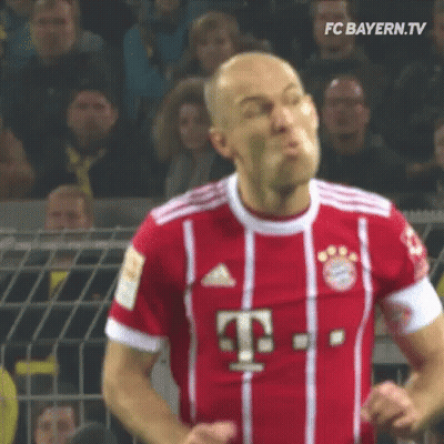 A Soccer Player Wearing A Red And White Jersey With The Letter T On It Is Making A Funny Face . GIF