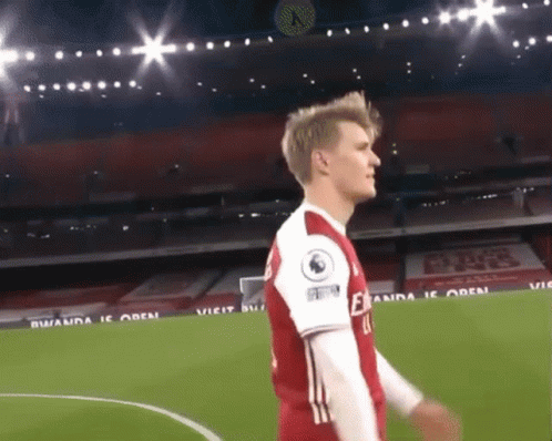 A Soccer Player Wearing A Red And White Jersey With The Number 11 On The Back GIF