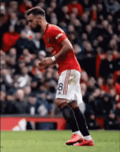 A Soccer Player Wearing A Red And White Jersey With The Number 8 On It Is Running On The Field . GIF
