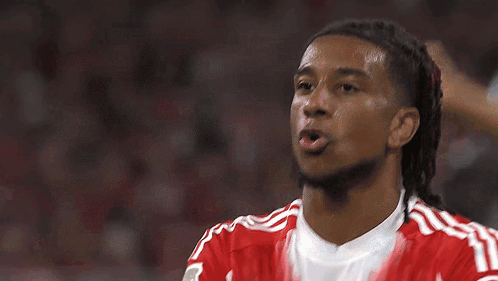 A Soccer Player Wearing A Red And White Jersey With The Word Allianz On It GIF