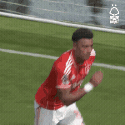 A Soccer Player Wearing A Red And White Jersey With The Word Forest On It GIF