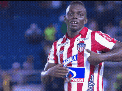 A Soccer Player Wearing A Red And White Striped Jersey With Aguila On It GIF