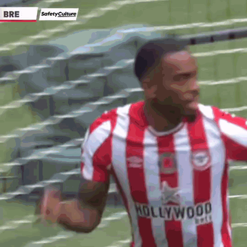 A Soccer Player Wearing A Red And White Striped Jersey With The Word Hollywood On It GIF