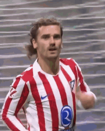 A Soccer Player Wearing A Red And White Striped Shirt Is Running On A Field . GIF