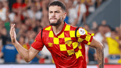 A Soccer Player Wearing A Red And Yellow Checkered Jersey With Umbro Written On It GIF