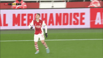 A Soccer Player Wearing A Red Emirates Jersey Celebrates A Goal GIF