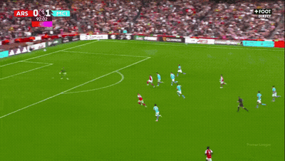 A Soccer Player Wearing A Red Emirates Jersey Is Being Helped By Another Player GIF