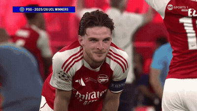 A Soccer Player Wearing A Red Emirates Jersey Smiles GIF