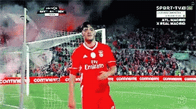 A Soccer Player Wearing A Red Emirates Jersey Stands On A Field GIF