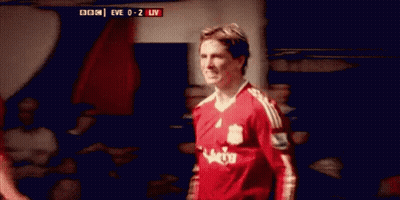 A Soccer Player Wearing A Red Jersey Is Standing In A Locker Room . GIF