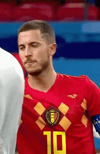 A Soccer Player Wearing A Red Jersey With The Number 10 On It Is Standing Next To Another Player On The Field . GIF