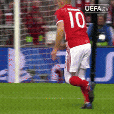 A Soccer Player Wearing A Red Jersey With The Number 10 On It GIF