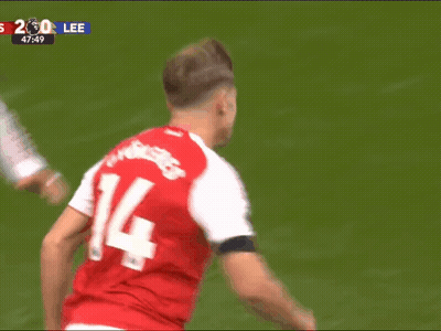 A Soccer Player Wearing A Red Jersey With The Number 14 On It GIF