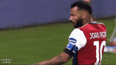 A Soccer Player Wearing A Red Jersey With The Number 14 On The Back GIF