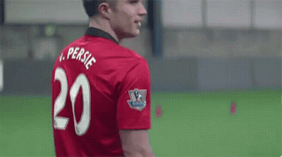 A Soccer Player Wearing A Red Jersey With The Number 20 On The Back Is Smiling . GIF
