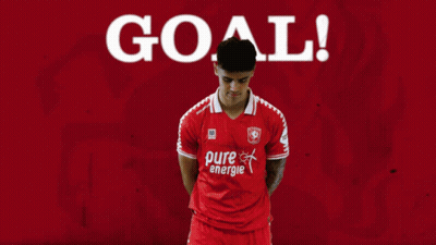 A Soccer Player Wearing A Red Pure Energie Shirt Celebrates A Goal GIF