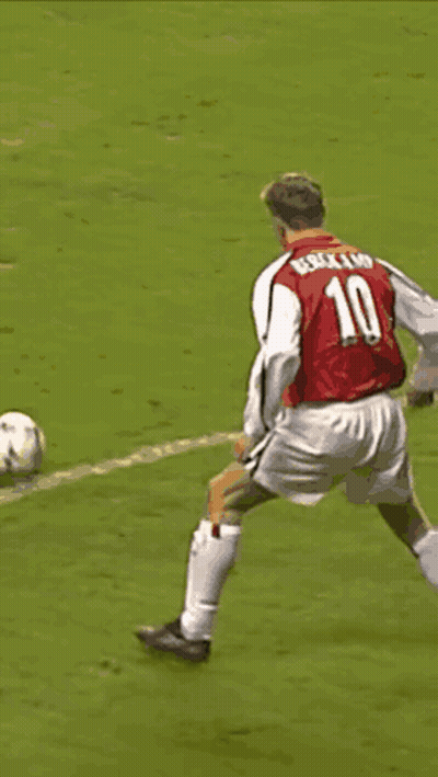 A Soccer Player Wearing A Red Shirt That Says ' Dri ' On It Is Being Tackled By Another Player GIF