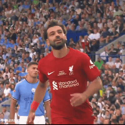 A Soccer Player Wearing A Red Shirt That Says Standard Chartered Is Running On The Field . GIF
