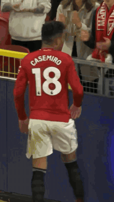 A Soccer Player Wearing A Red Shirt With The Number 18 On It GIF