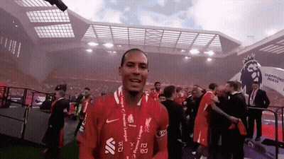 A Soccer Player Wearing A Red Shirt With The Word Liverpool On It GIF