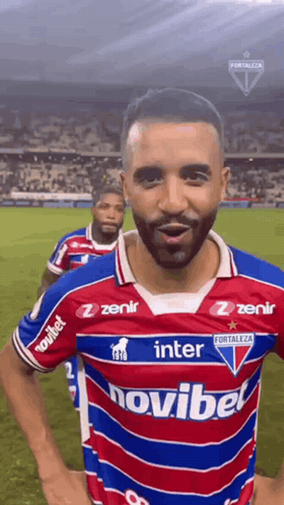 A Soccer Player Wearing A Red , White And Blue Jersey With The Word Novibet On It . GIF