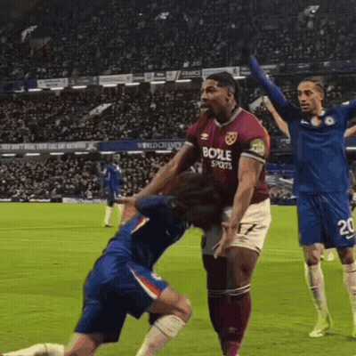 A Soccer Player Wearing A Shirt That Says Boole Sports Is Being Tackled By Another Player GIF