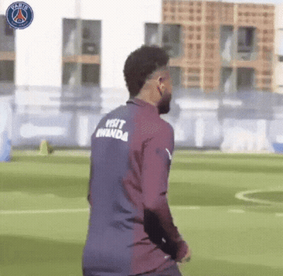 A Soccer Player Wearing A Shirt That Says Visit Rwanda On The Back Is Walking On A Field . GIF
