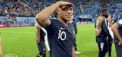 A Soccer Player Wearing A Shirt With The Number 10 On It Salutes The Crowd . GIF
