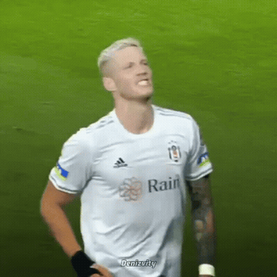 A Soccer Player Wearing A White Adidas Shirt Is Standing On A Field . GIF