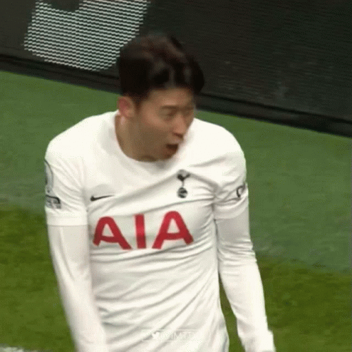 A Soccer Player Wearing A White Aia Jersey Is Standing On The Field . GIF