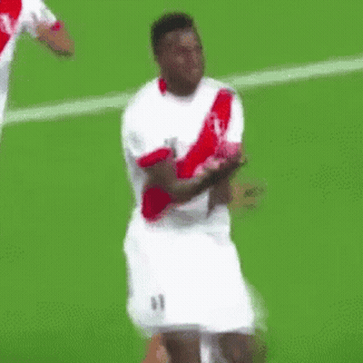 A Soccer Player Wearing A White And Red Jersey Is Dancing On The Field . GIF