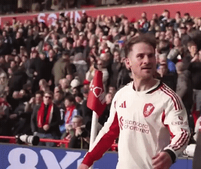 A Soccer Player Wearing A White And Red Jersey With The Word Standard On It GIF