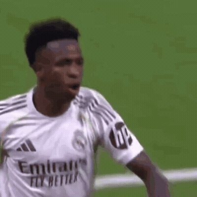 A Soccer Player Wearing A White Emirates Fly Better Jersey Is Standing On A Field . GIF